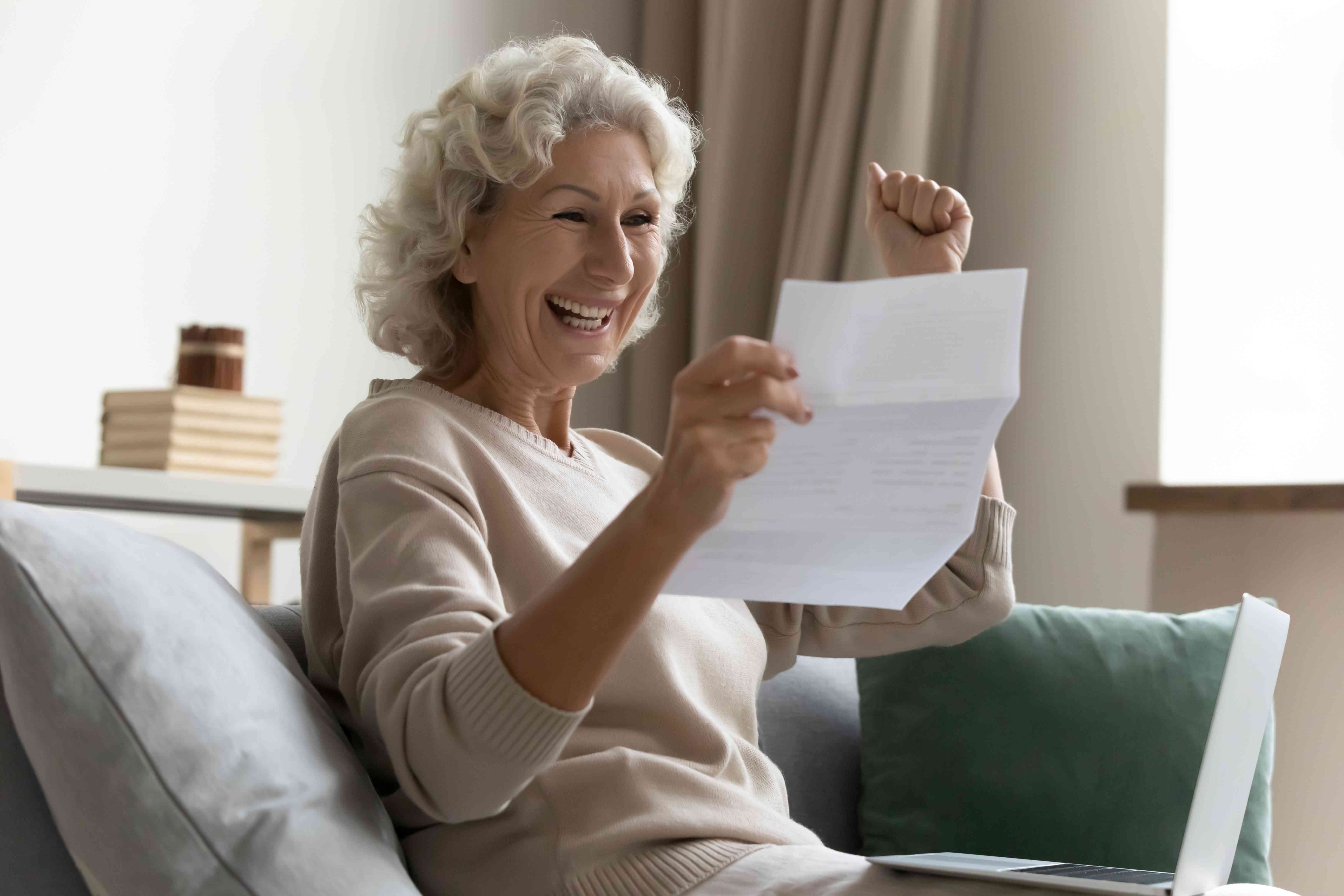 smiling woman reading a letter