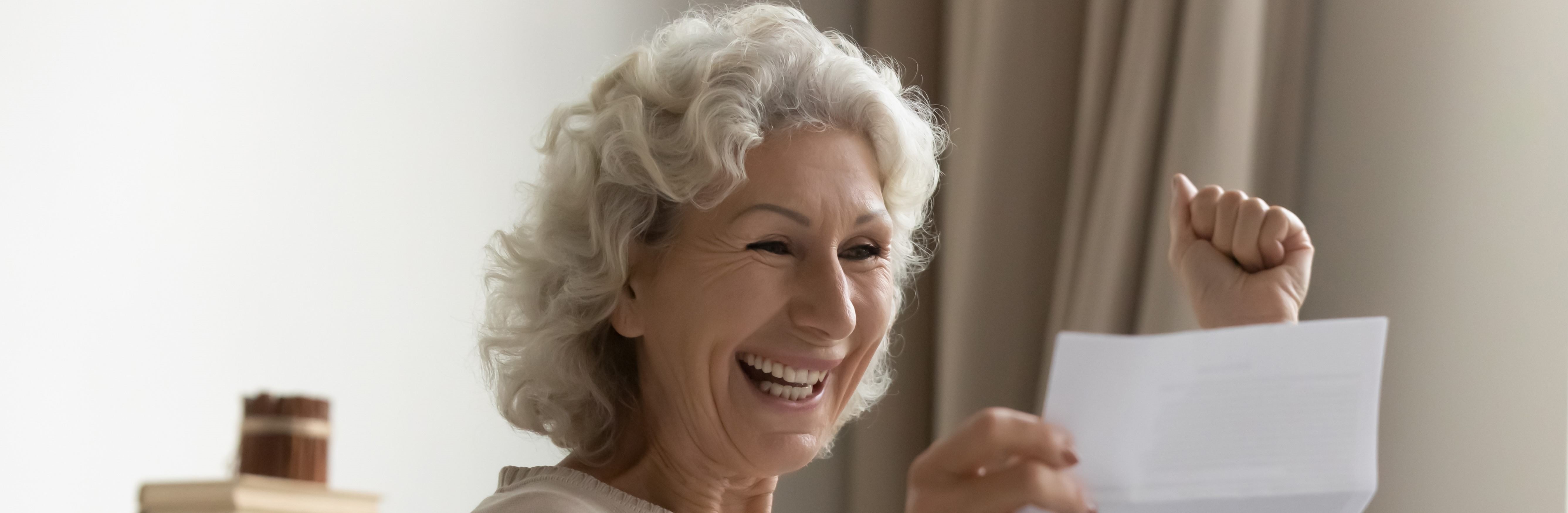 smiling woman reading a letter